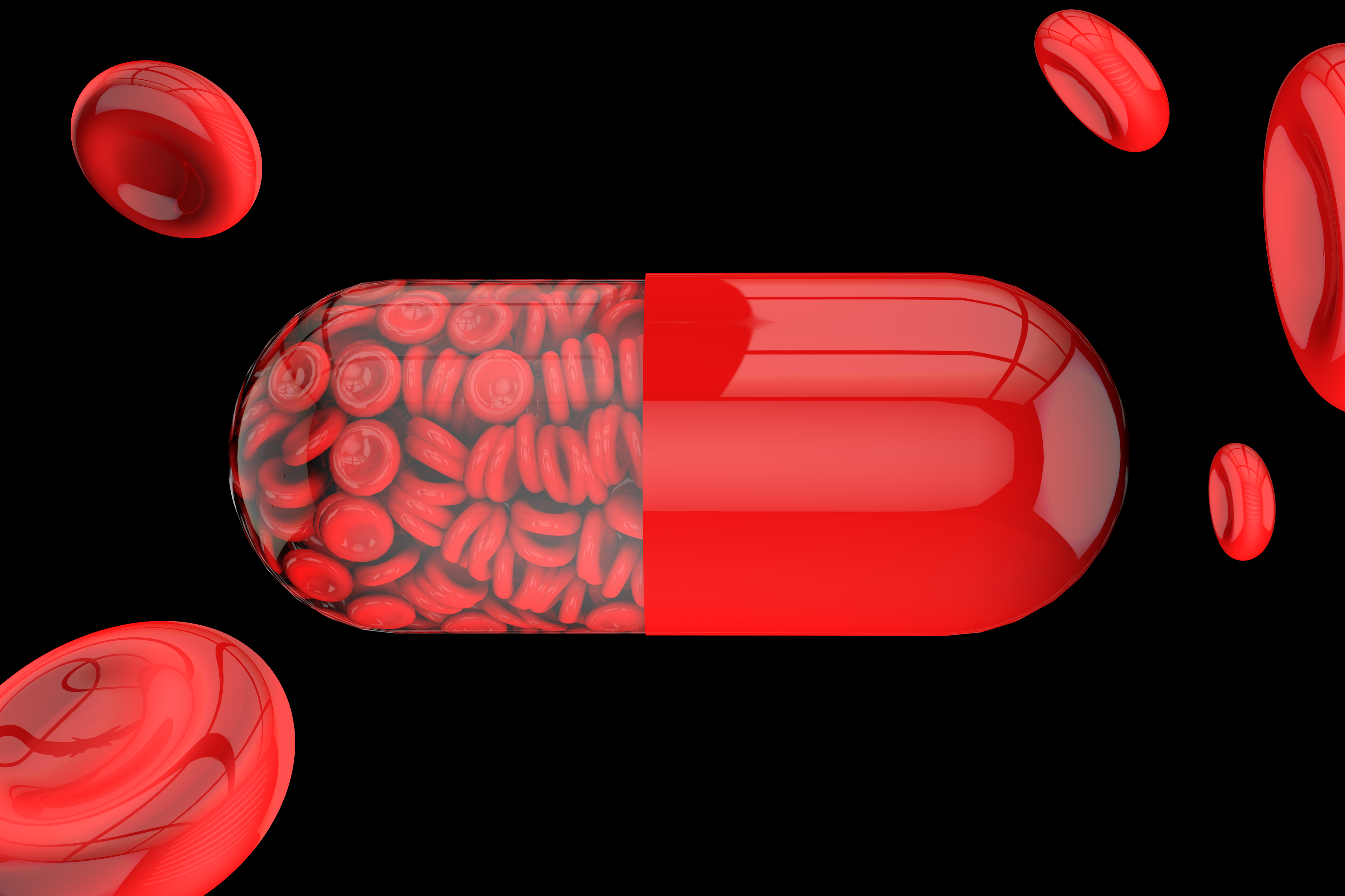 A large red pill with one half showing full of tiny red blood cells, surrounded by several shiny red blood cells on a black background.