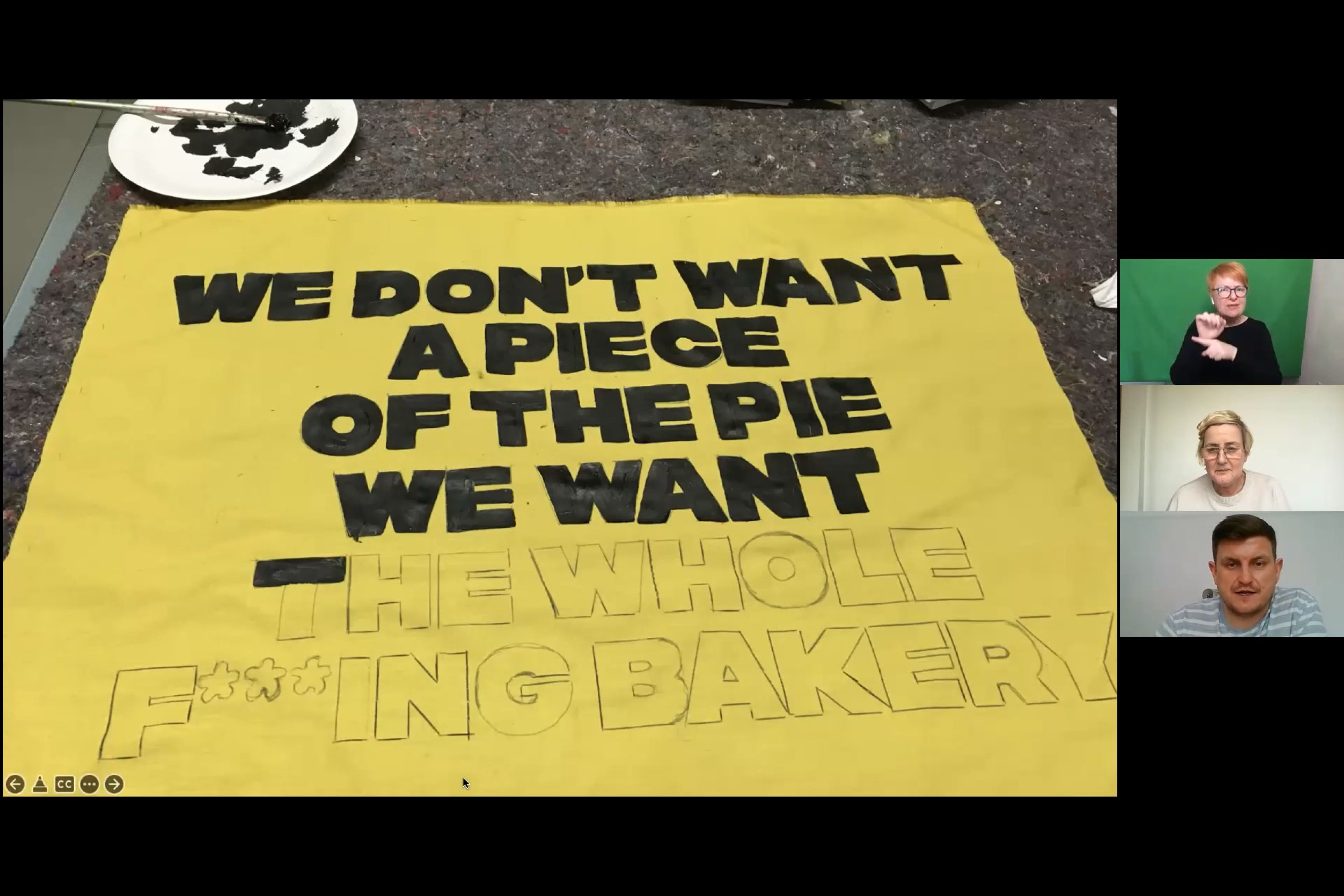 Three people on a zoom call. A large picture is shown of a yellow piece of fabric. The words read "We don't want a piece of the pie. We can the whole fucking bakery".