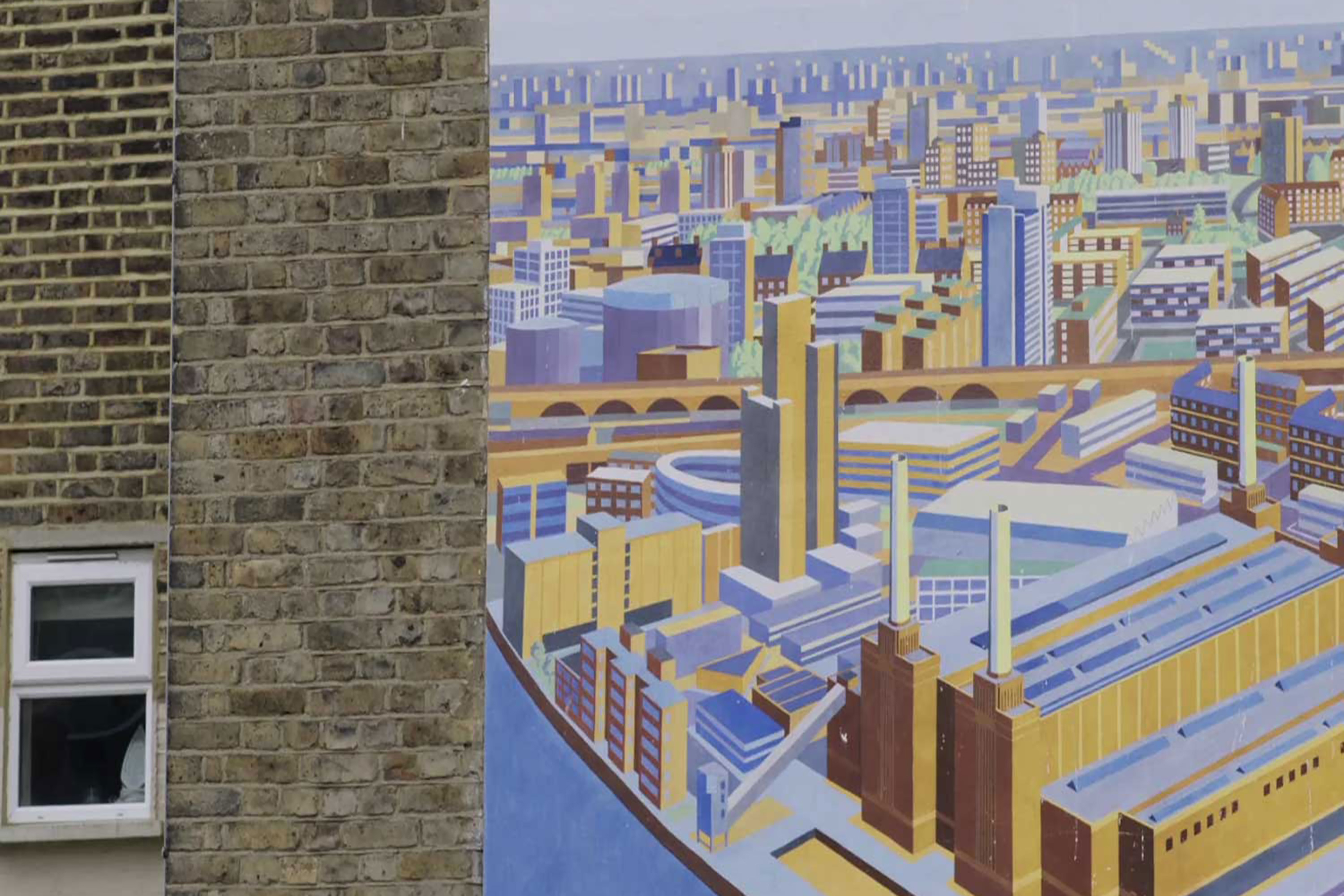 A photograph of a building with a two dimensional cityscape graphic mural placed next to the buildings window.