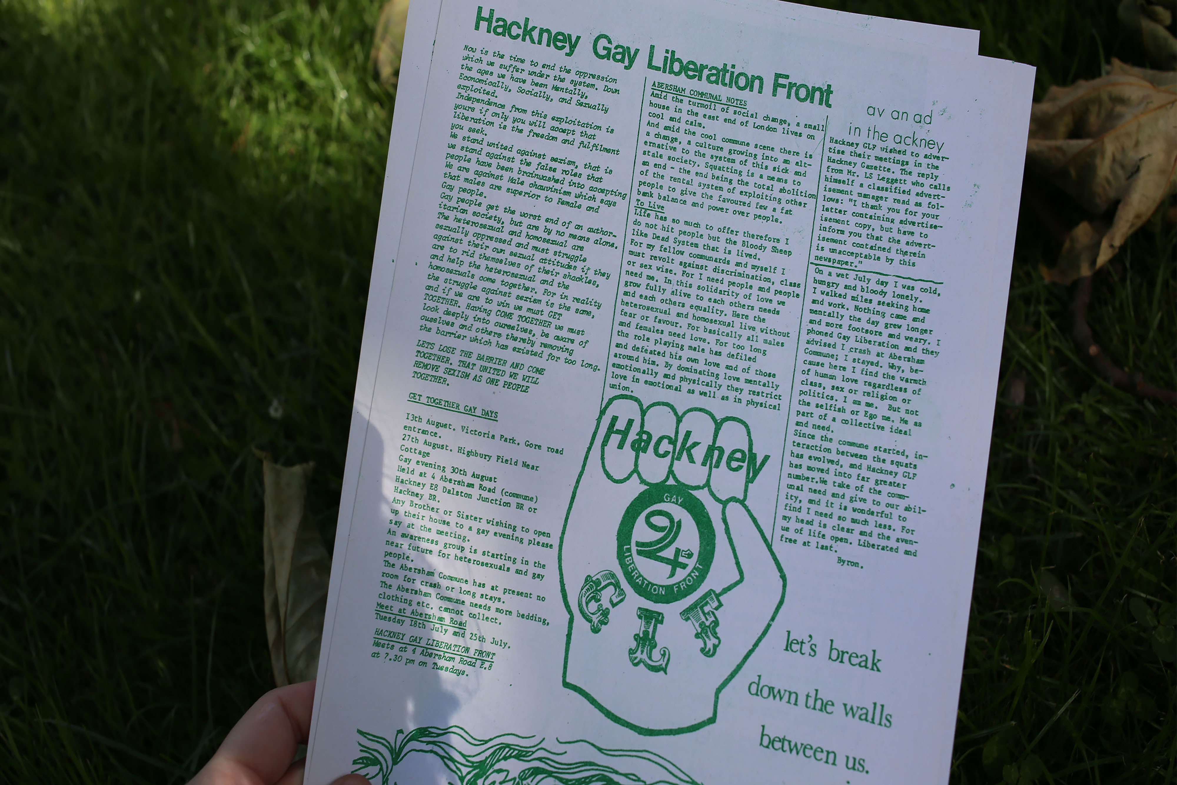 Someone holding a printout sheet in green front containing a news article.