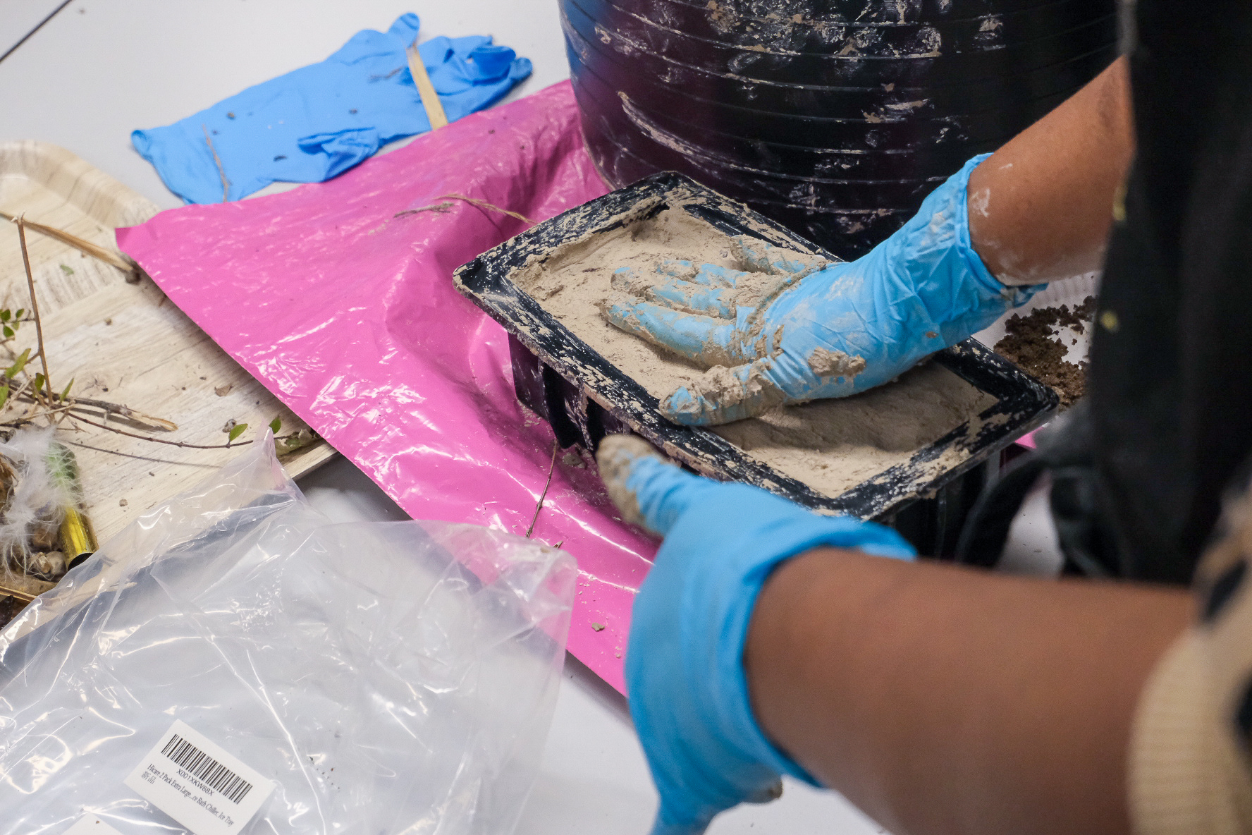 Hand forming a brick in a brick mould