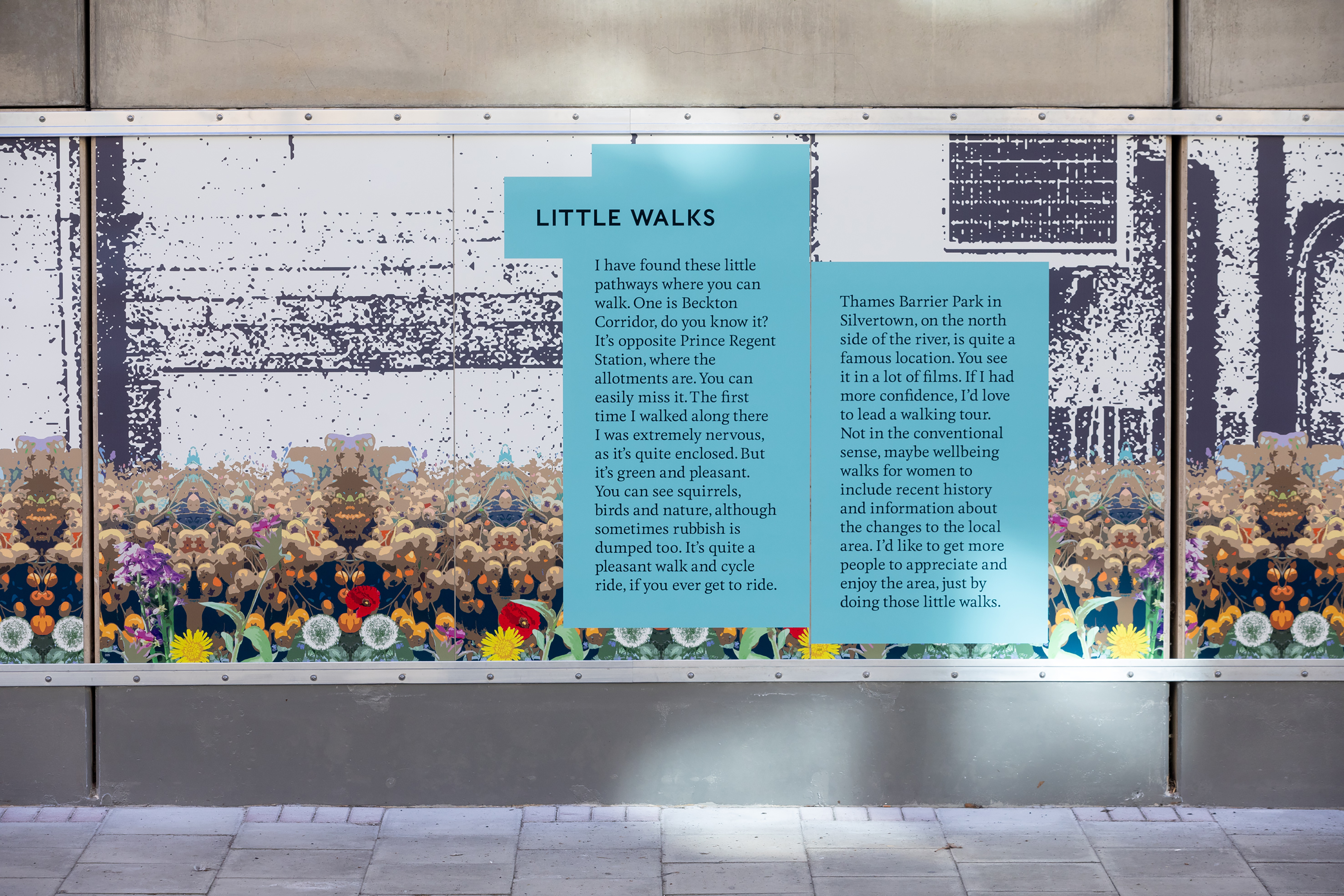 A close-up photograph of the trackside wall displaying a paragraph of text titled "Little Walks" written on light blue rectangles.