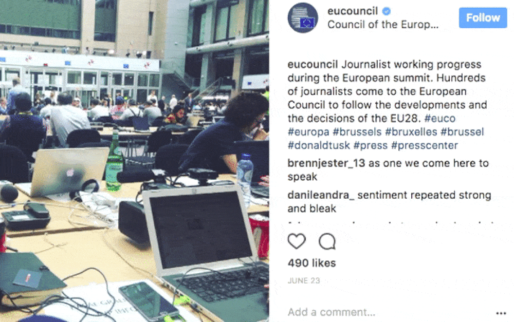 Moving image of an Instagram account with a picture on the left of a busy office full of laptops, wires and workers at tables, with a rolling social media comments section on the right.