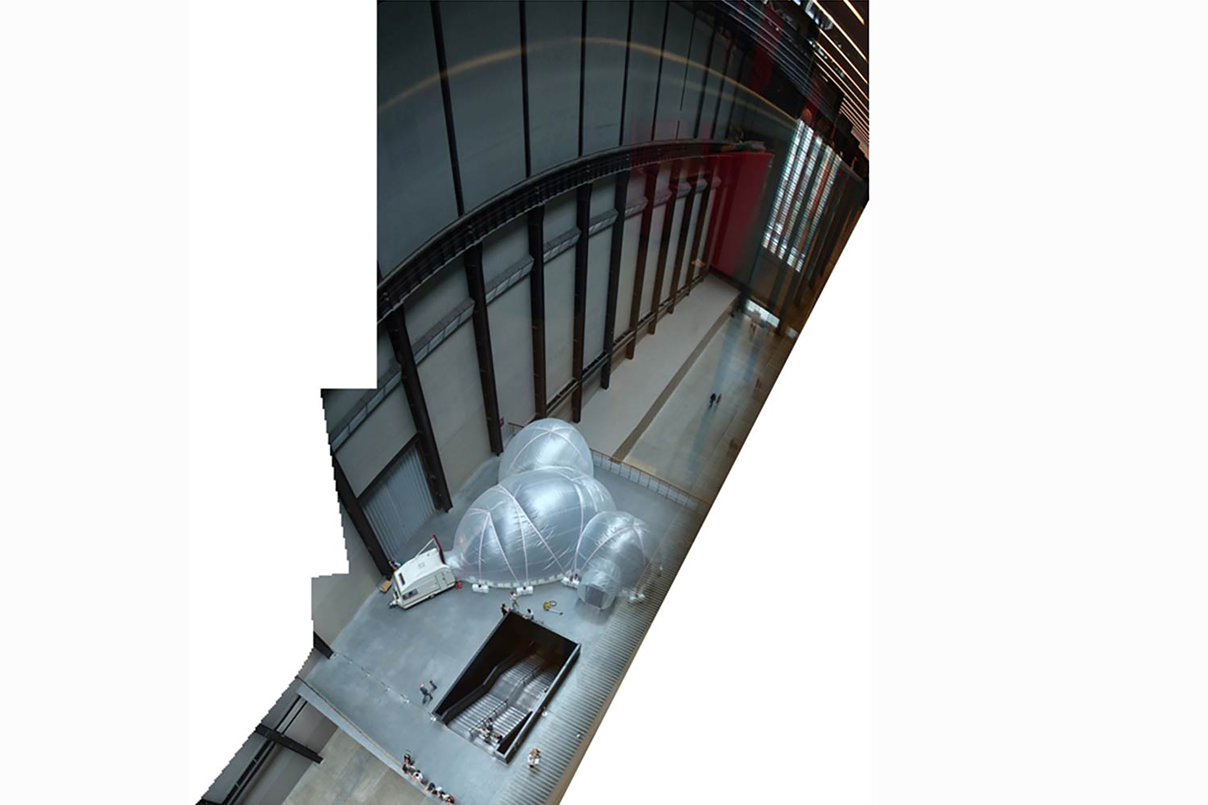 A birds eye view photograph of transparent dome bubbles inside the Tate Modern.