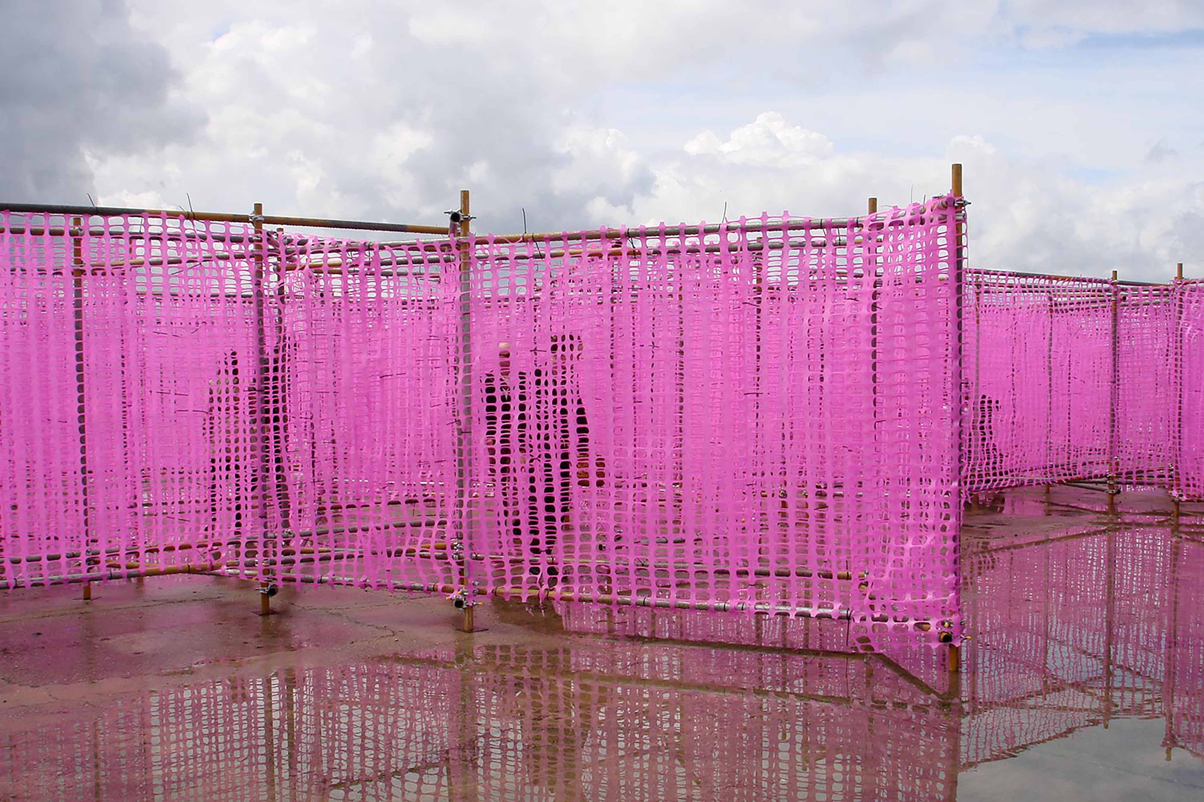 A photograph of a pink maze constructed from pink tape and scaffold.